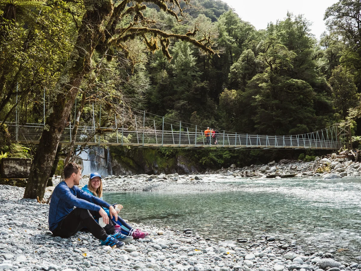 Hikers enjoying Giant Gate Waterfall, Milford Track