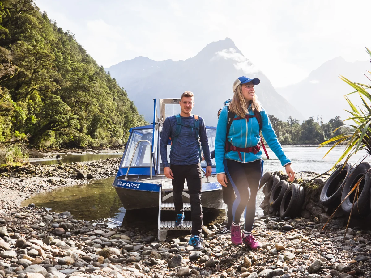 Hikers stepping off the Milford Track Water Taxi, Milford Sound